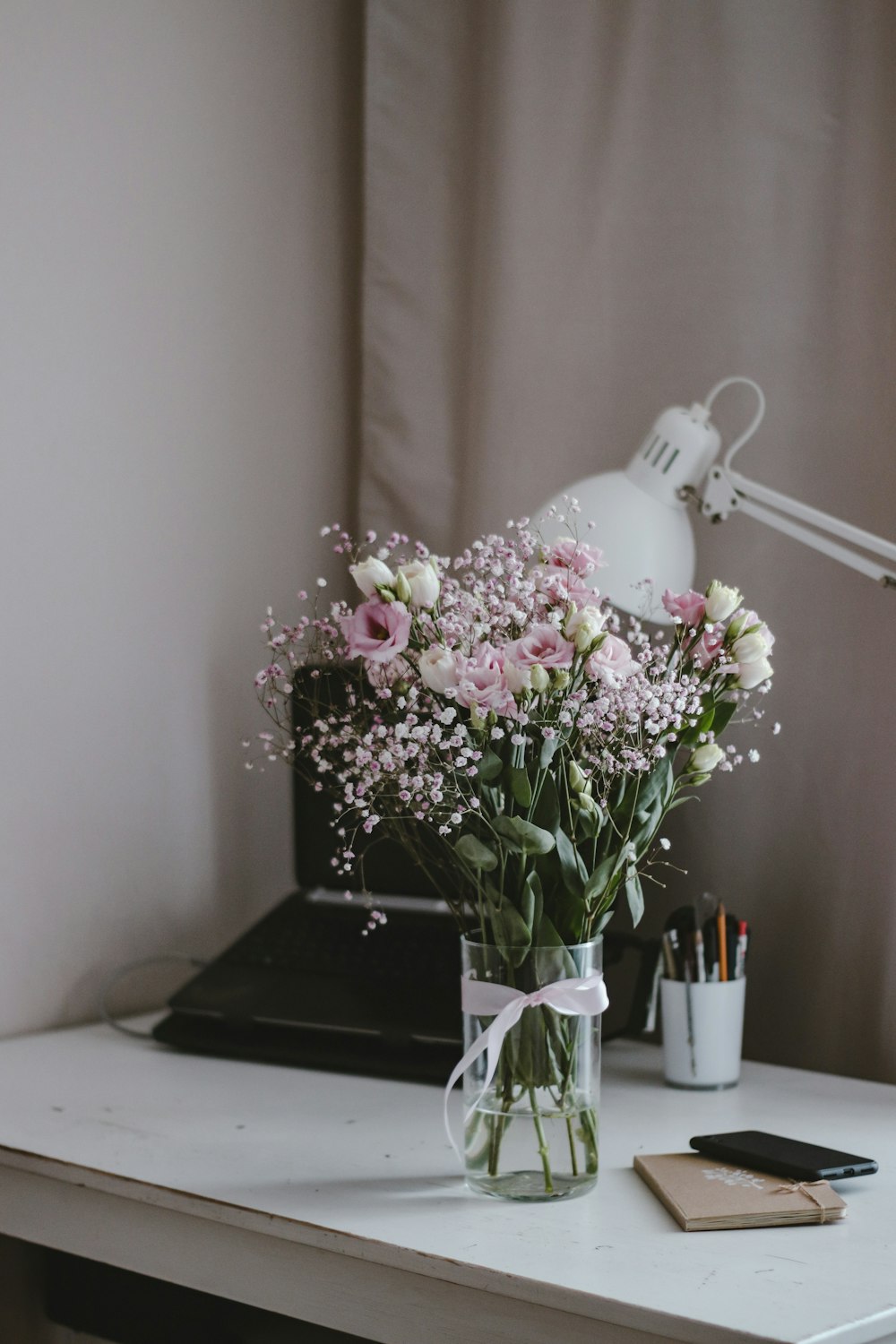 pink and white flowers on white ceramic vase