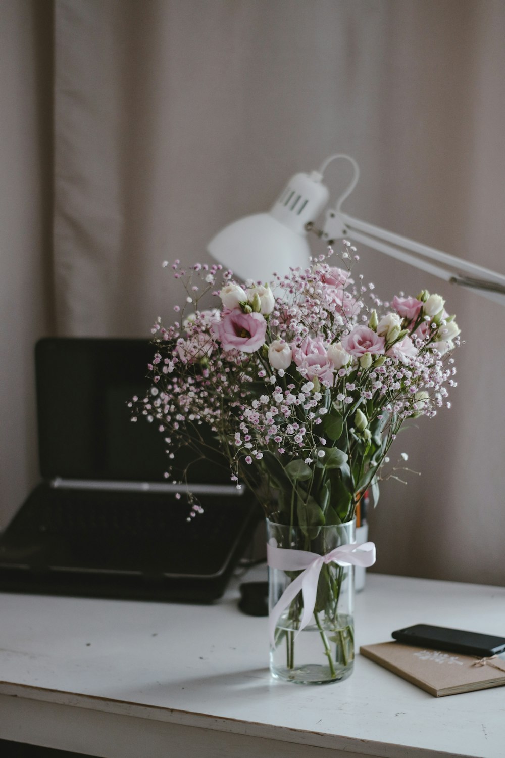 pink and white flowers on black rectangular tray