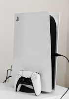 white playstation five console and controller