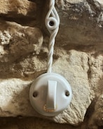 Close-up of hands wiring a light switch safely.