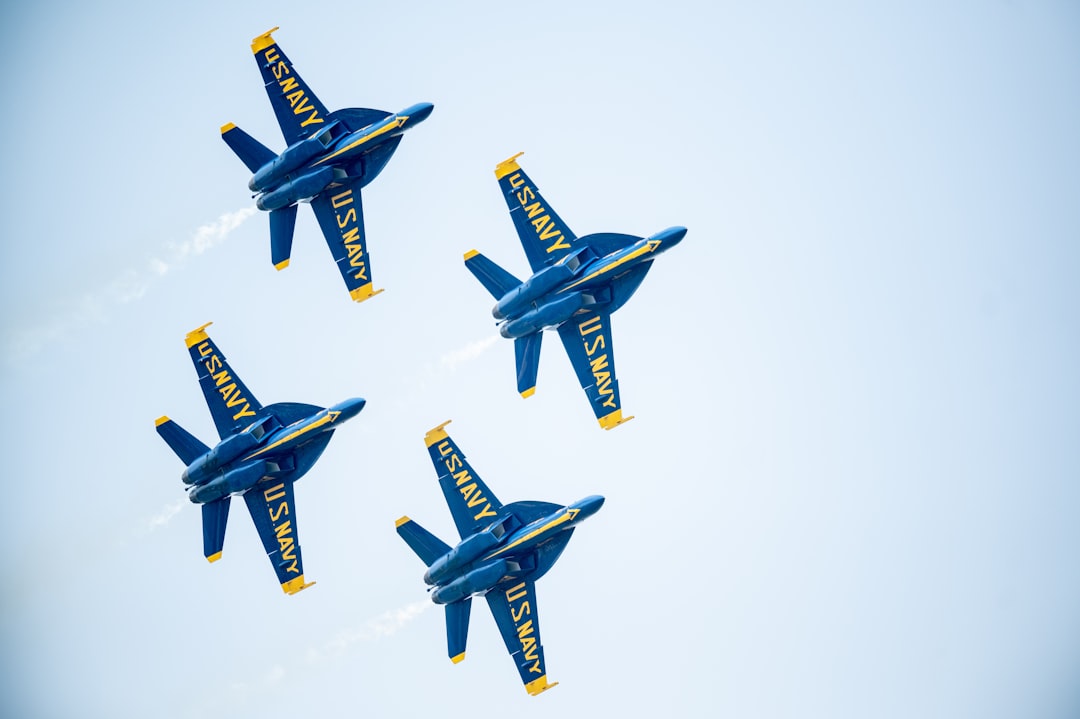 blue and yellow jet plane in mid air,