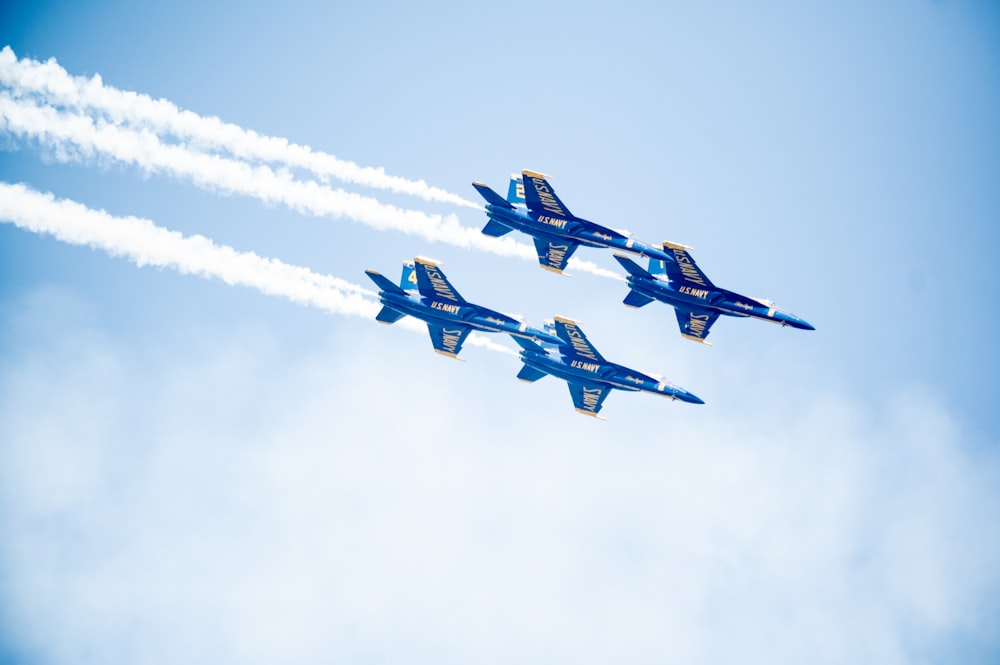 blue and white jet plane in mid air