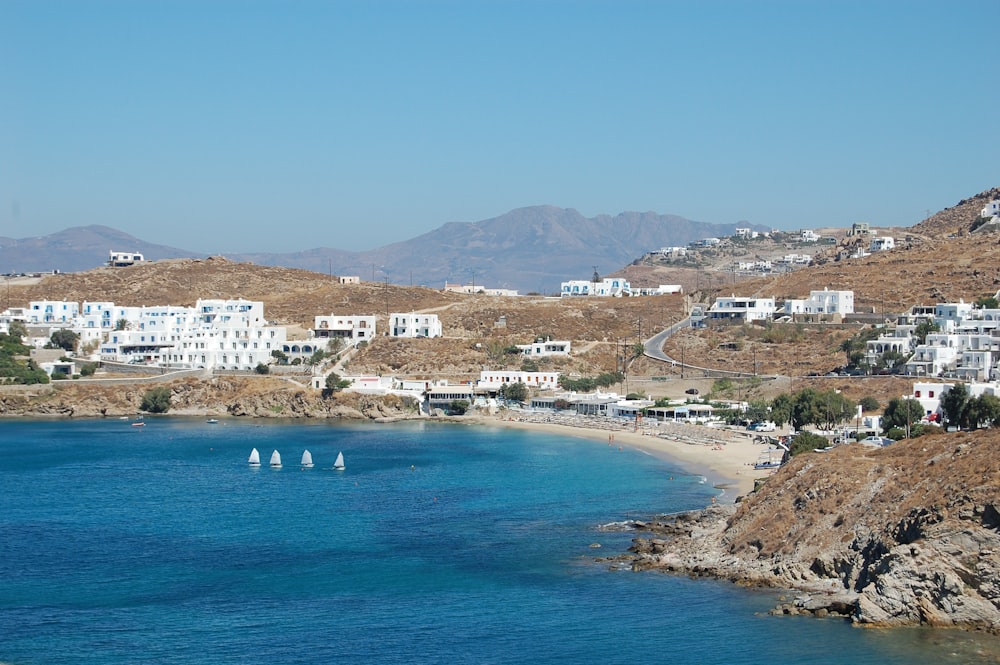 white and brown concrete buildings near blue sea under blue sky during daytime