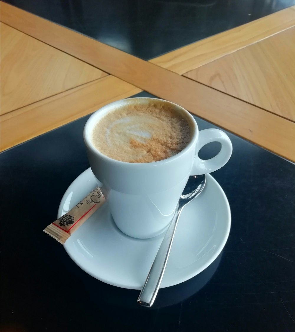 white ceramic mug on white ceramic saucer