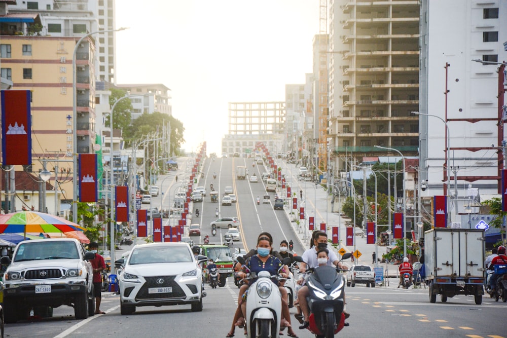 people riding motorcycle on road during daytime