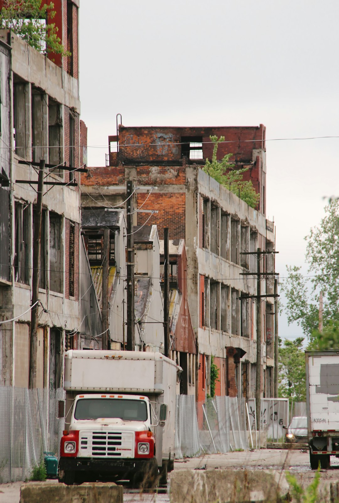 white van parked beside brown concrete building during daytime