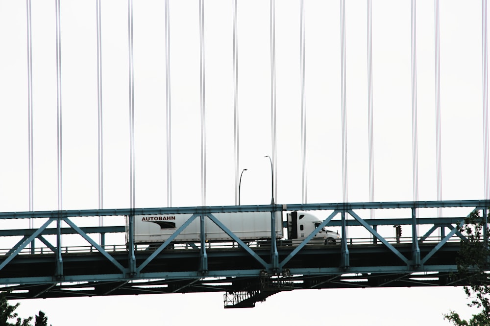 blue metal bridge under white sky during daytime