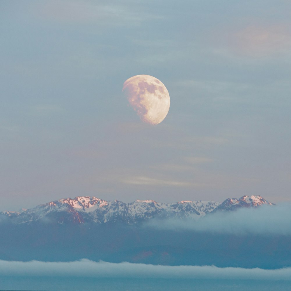 snow covered mountain under full moon