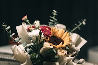 white and red flowers on black surface