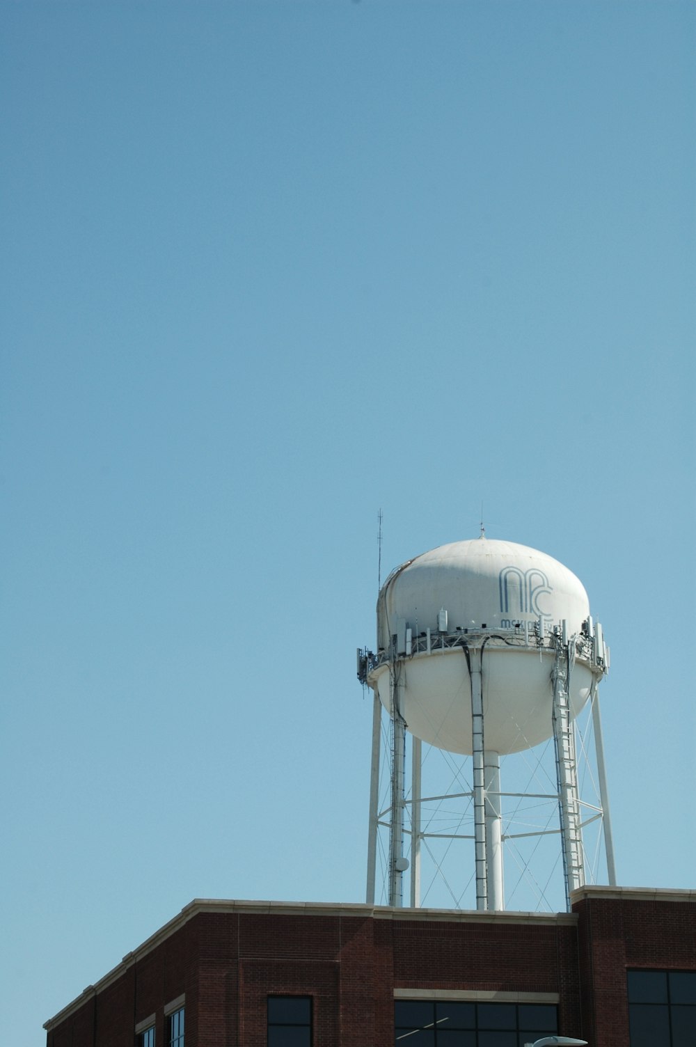 white and gray water tank under blue sky during daytime
