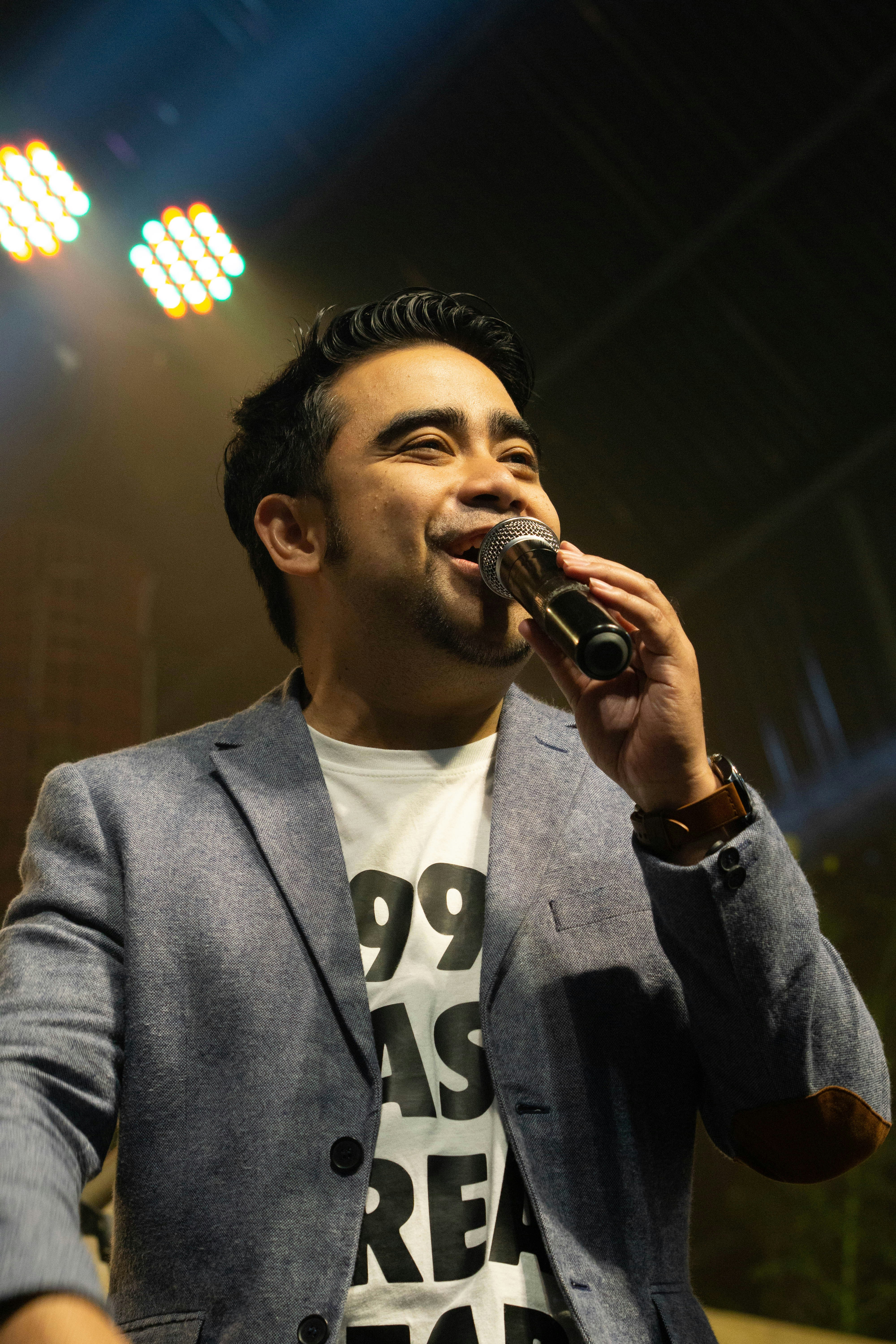 man in gray suit singing