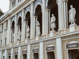 white concrete building with statues