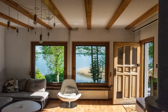 Bright lakeside room designed for Airbnb or short-term rental, with large windows overlooking a lake