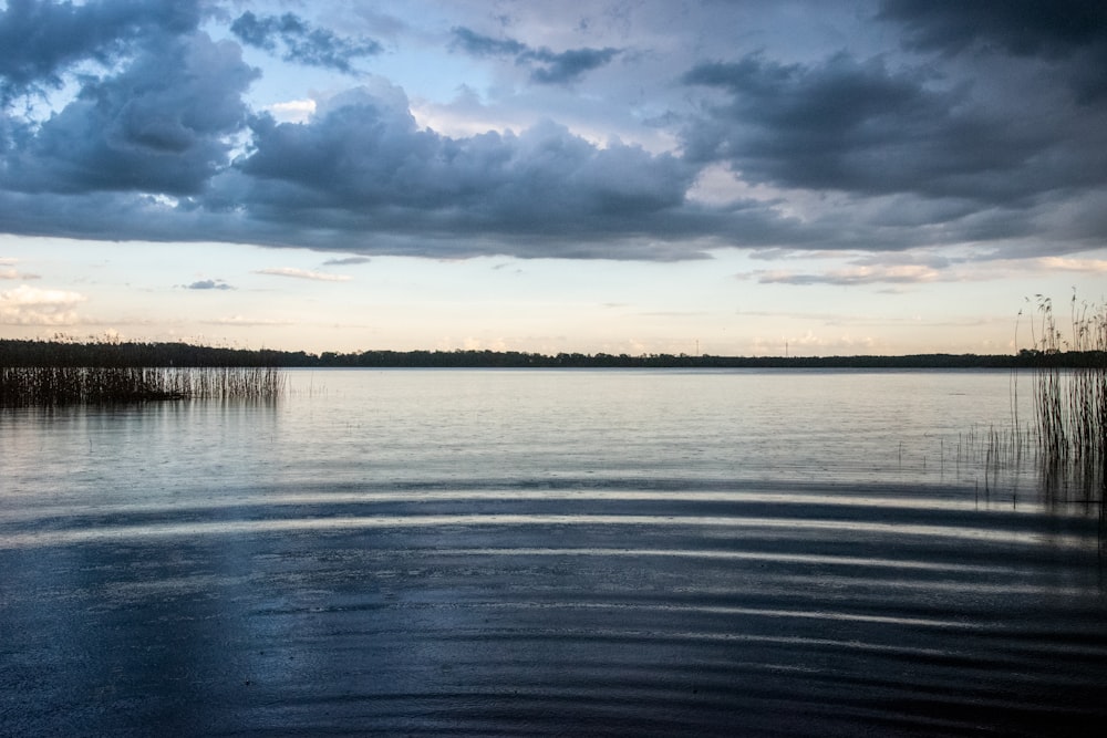 body of water under cloudy sky during daytime