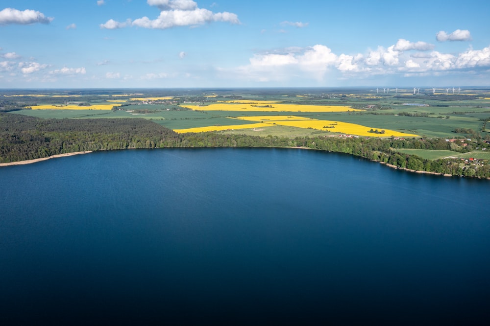 aerial view of green grass field near body of water during daytime