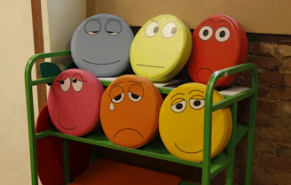 A playful display of funny face cushions arranged on a colorful sofa