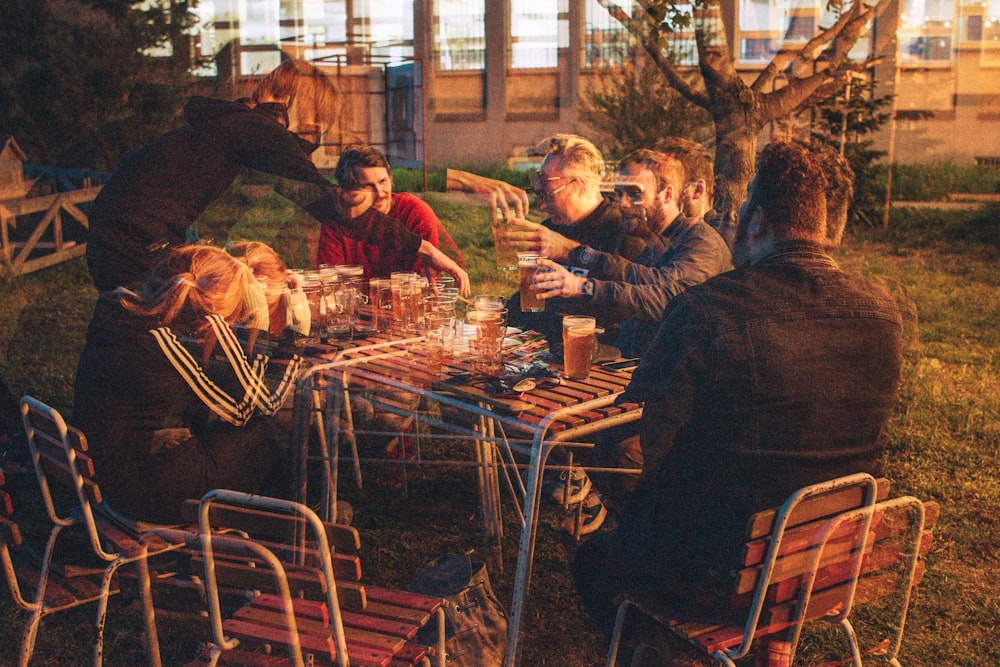 people sitting on chairs in front of table