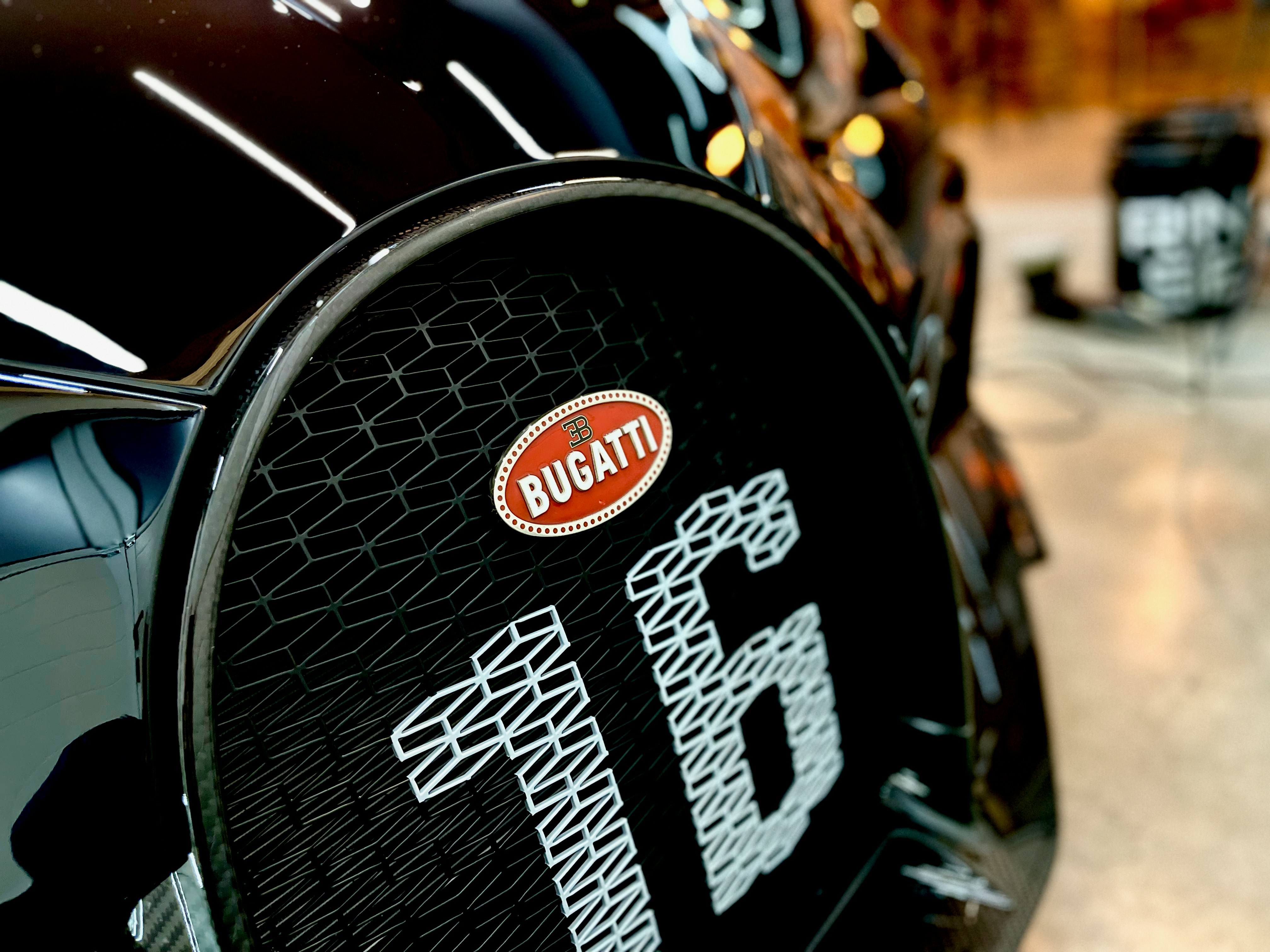 a close up of a black car with a red and white sticker on it