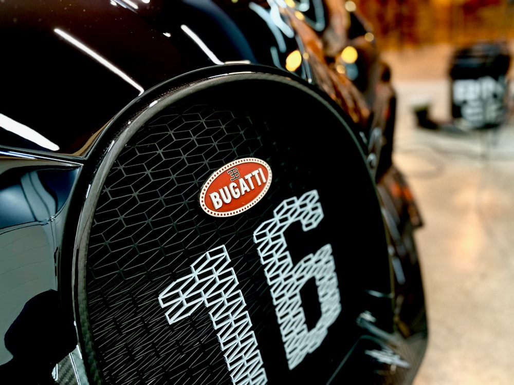 a close up of a black car with a red and white sticker on it