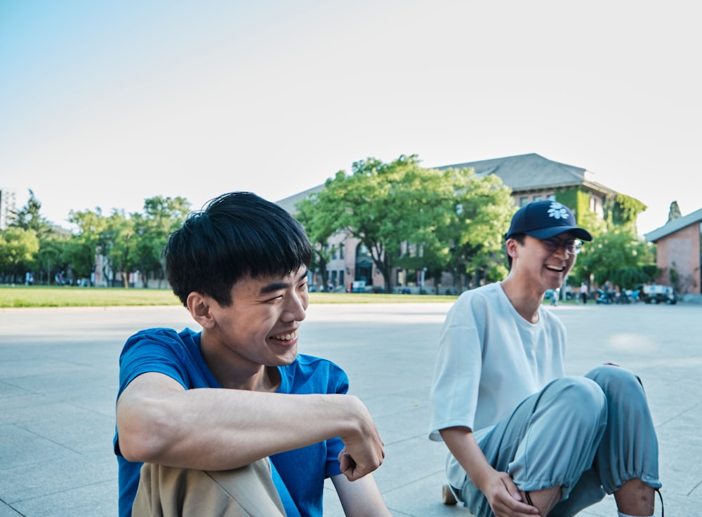 man in white crew neck t-shirt sitting on blue chair