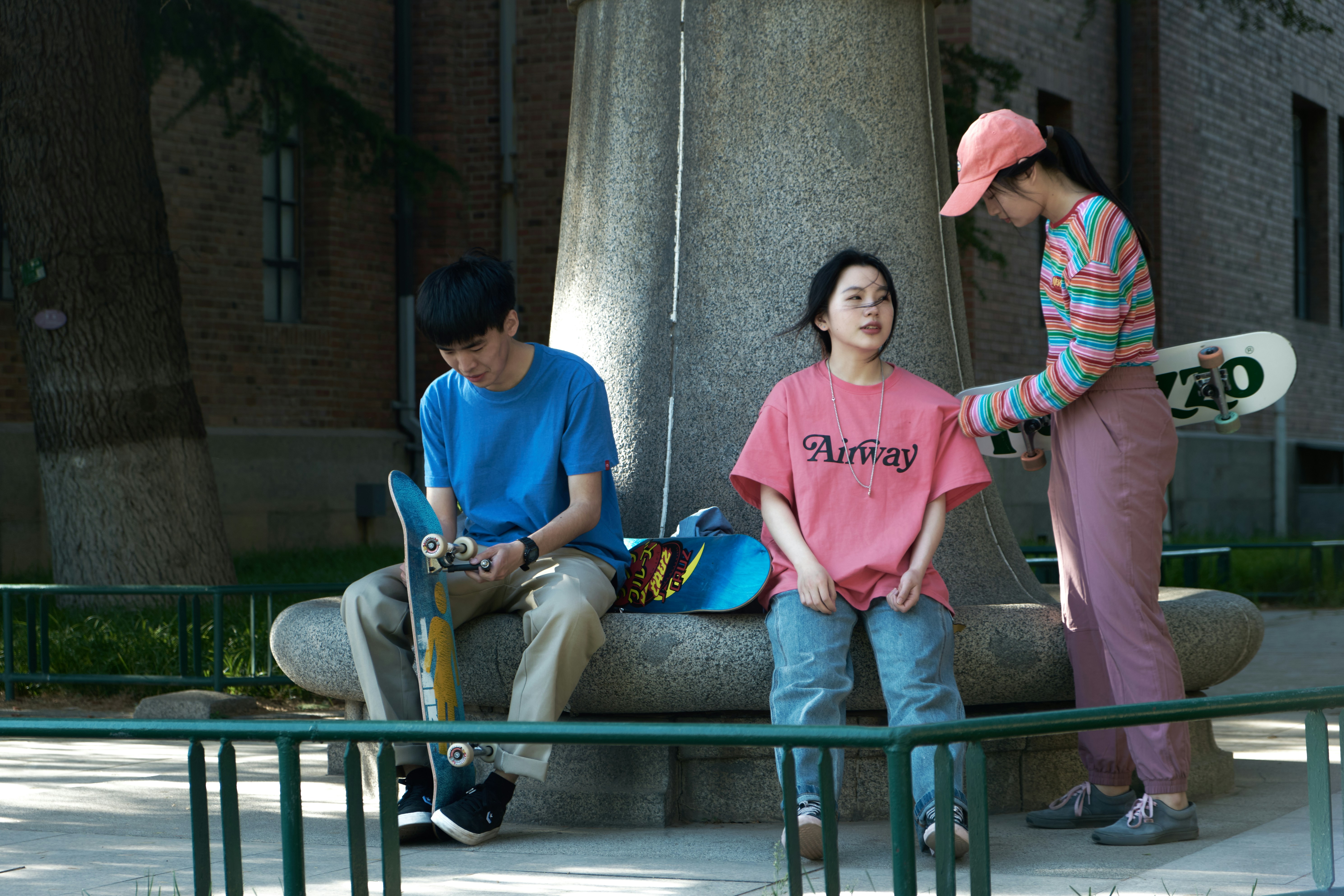 Man in Blue Polo Shirt Sitting Beside Woman in Pink