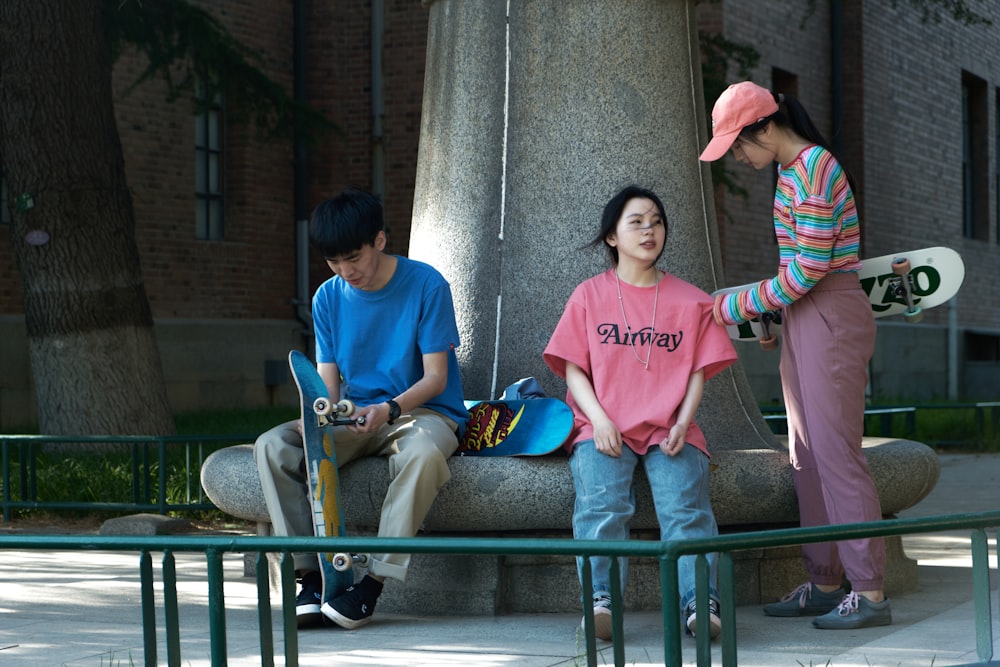 man in blue polo shirt sitting beside woman in pink and white striped long sleeve shirt