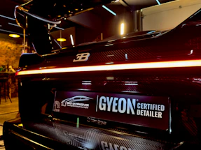 A sleek luxury car being detailed at First Impressions Auto Detailing.