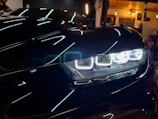Side view of a car with newly installed efficient auto lights glowing warmly.