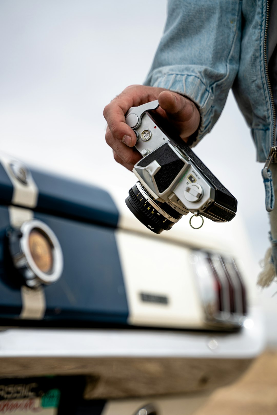 person holding black and silver camera