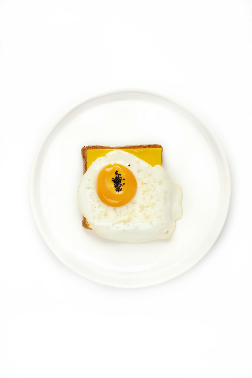 white and yellow egg on white ceramic plate