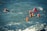 A group of people wearing red helmets and yellow life jackets are swimming together in the ocean. The water is choppy with visible waves, and the individuals appear to be participating in a water-based activity or training exercise.