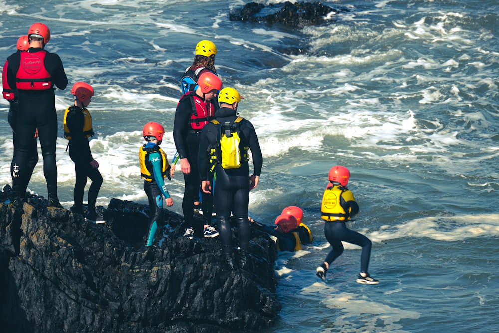 people in yellow and blue swimming suit on water during daytime