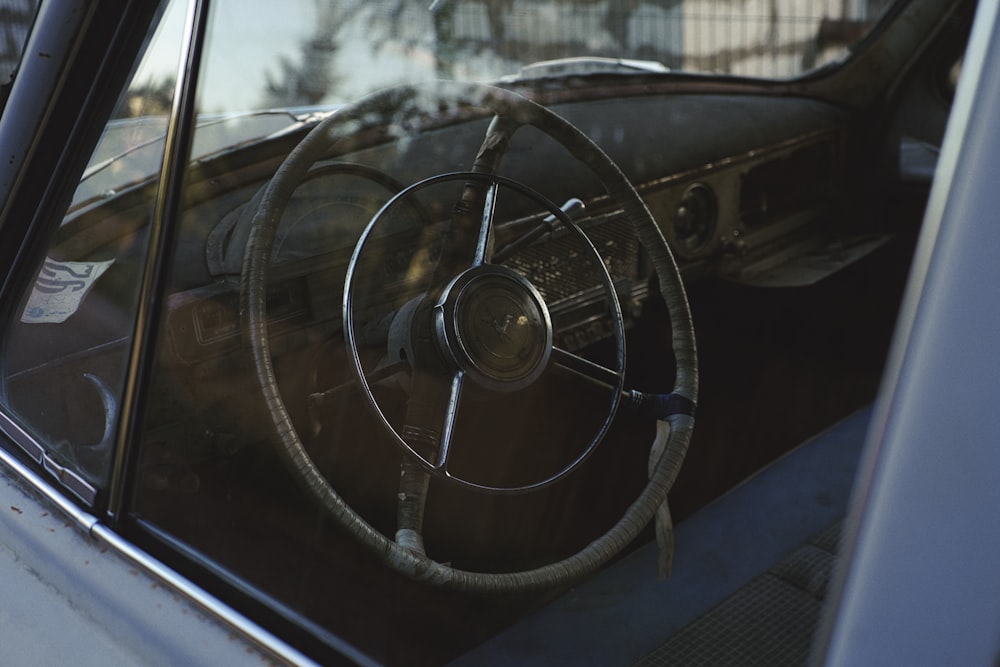 black car steering wheel during daytime