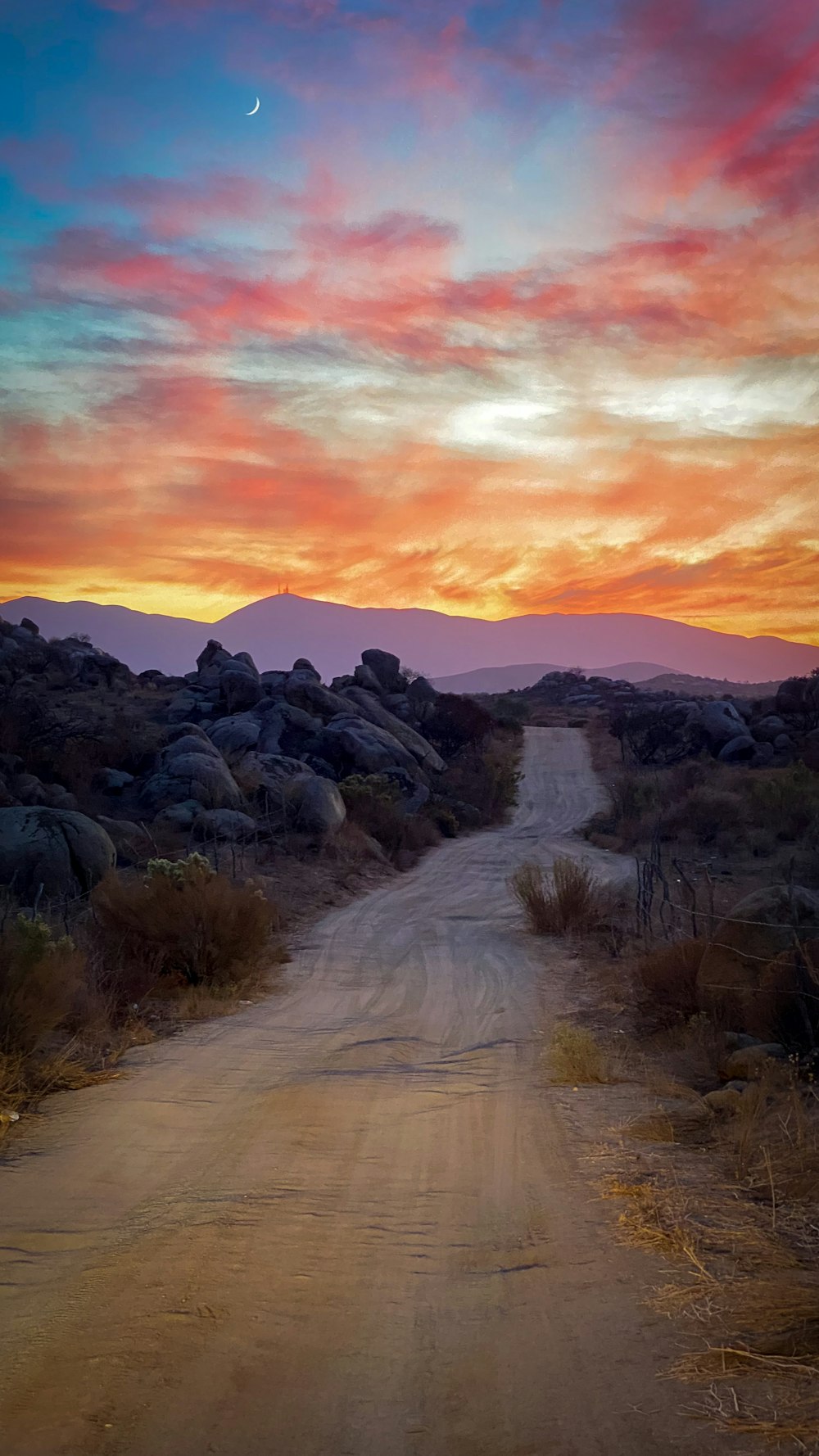 brown rocky mountain under orange and blue sky