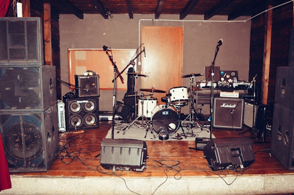 A cozy, rustic stage setup with Trouble Creek's instruments ready for a lively performance.