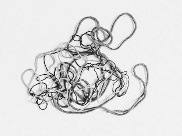 A black and white image of a tangle of string.