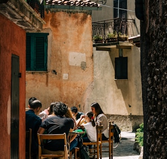 people sitting on brown wooden chairs during daytime