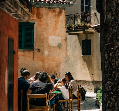 people sitting on brown wooden chairs during daytime