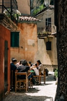 people sitting on brown wooden chairs during daytime