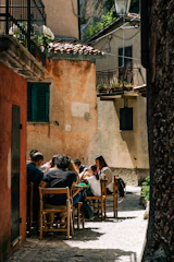 people sitting on brown wooden chairs during daytime