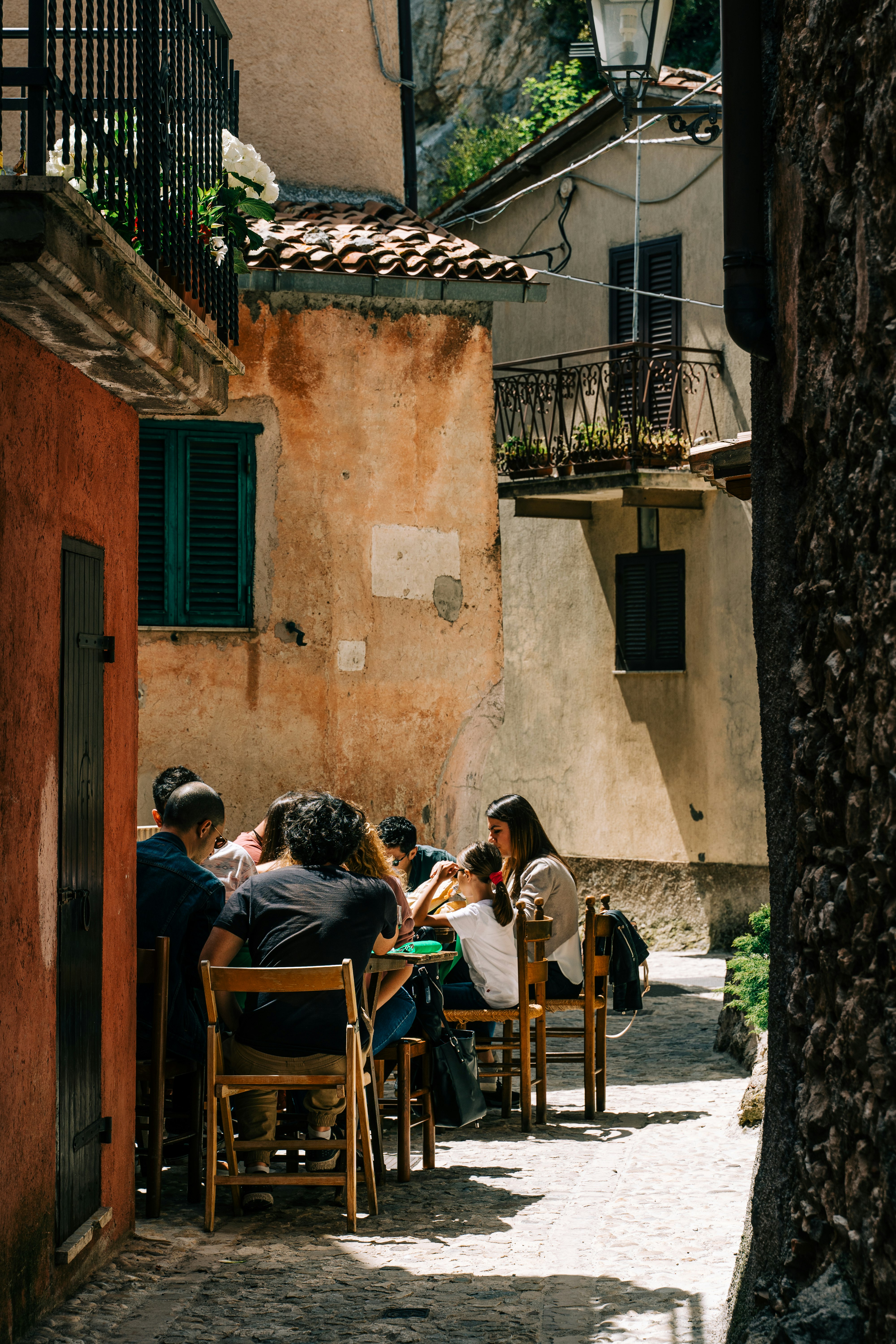 people sitting on brown wooden chairs during daytime