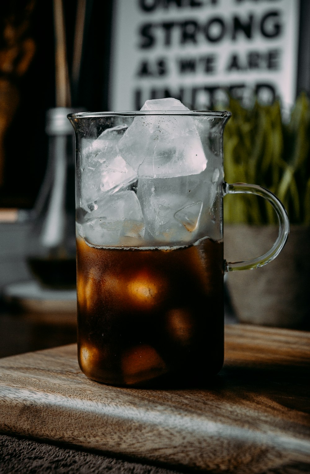 clear glass mug with brown liquid