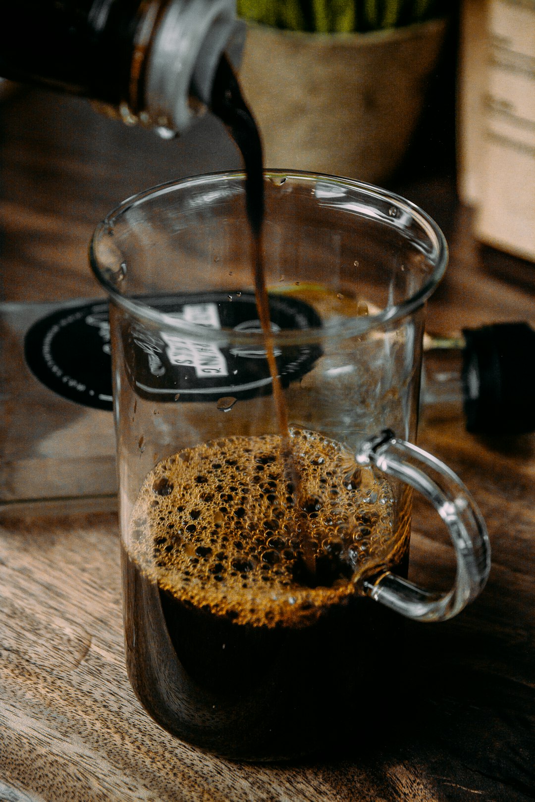 clear glass mug with brown liquid