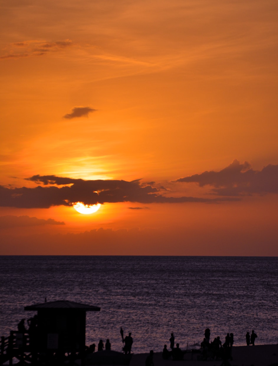 silhouette of boat on sea during sunset