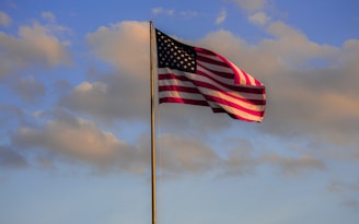 us a flag under cloudy sky during daytime