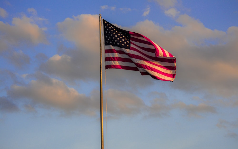 us a flag under cloudy sky during daytime