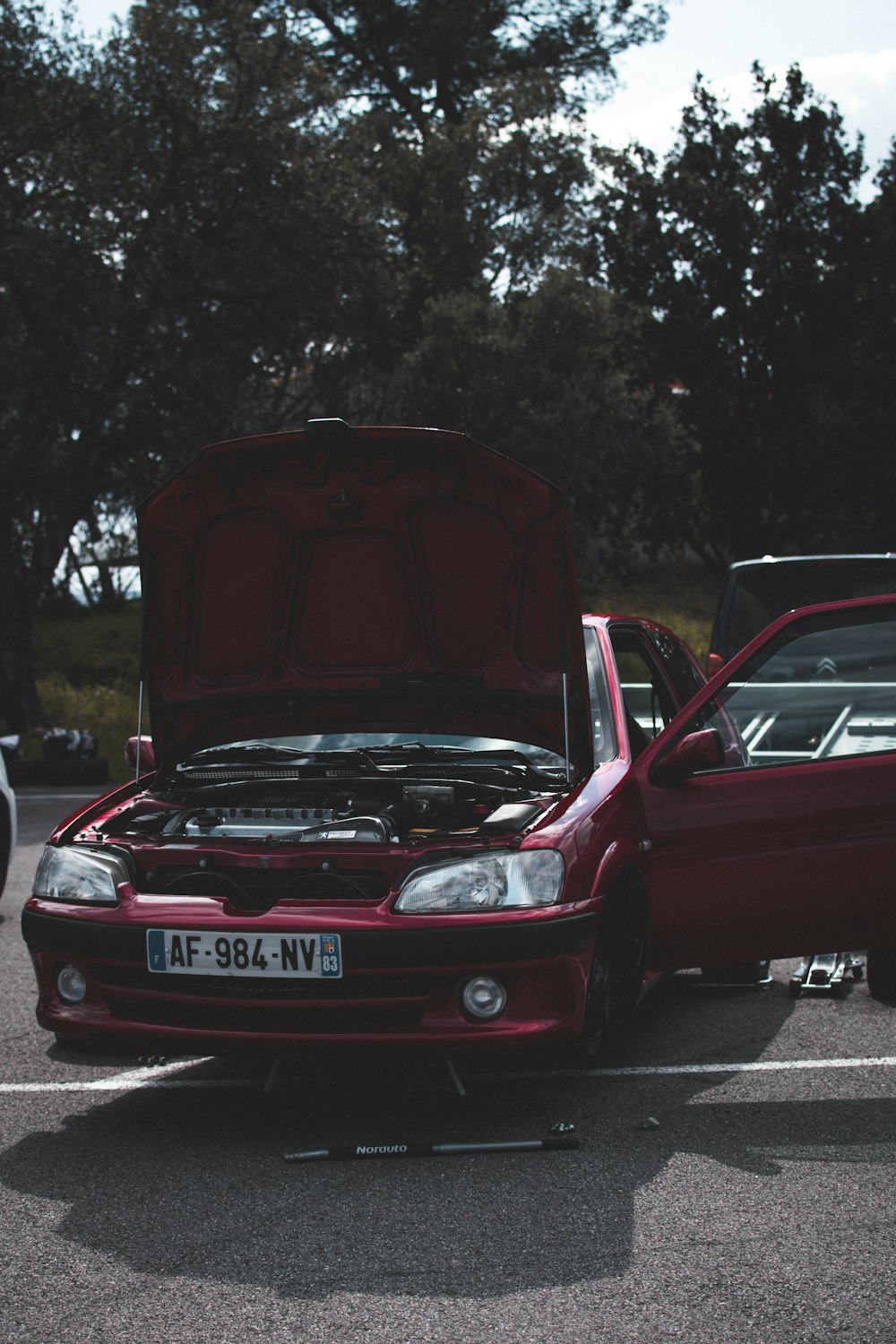 red bmw m 3 parked on road during daytime