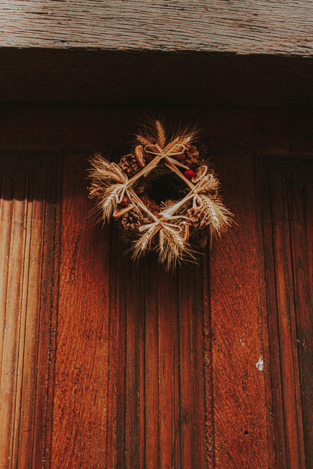 brown and white wreath on brown wooden wall