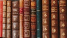 piled of books on brown wooden shelf