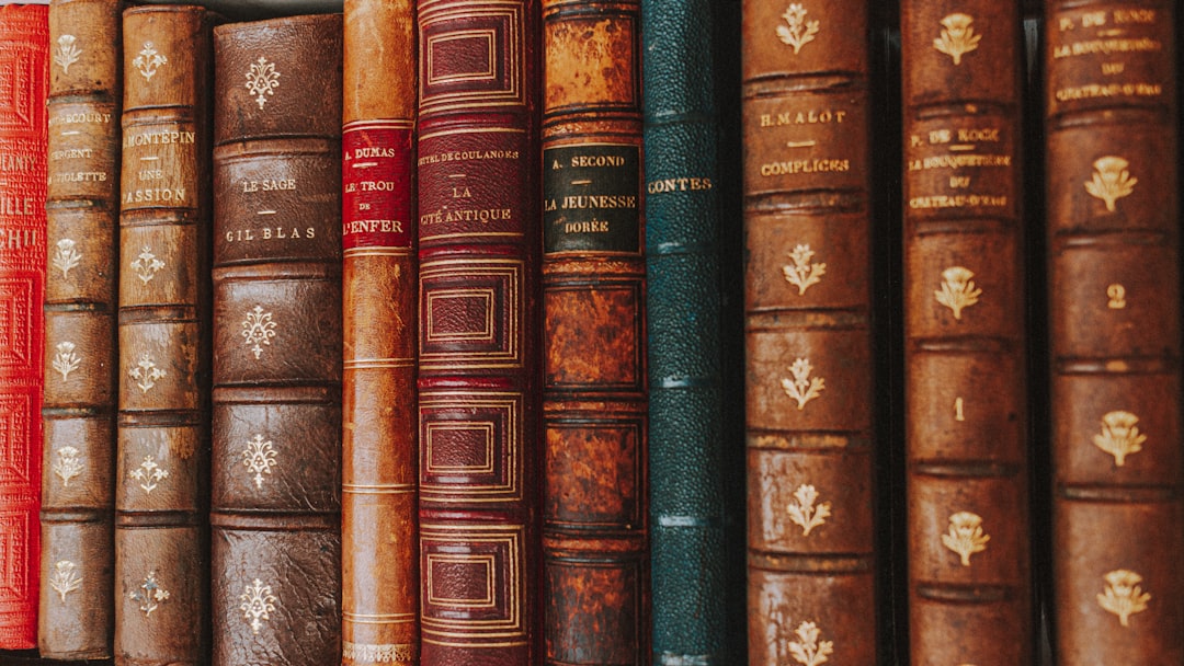 piled of books on brown wooden shelf